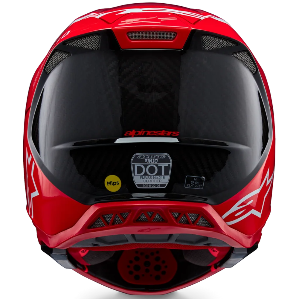 A red full-face motocross helmet with a dark visor, featuring the Alpinestars logo and a DOT 4 safety sticker on a clean white background.