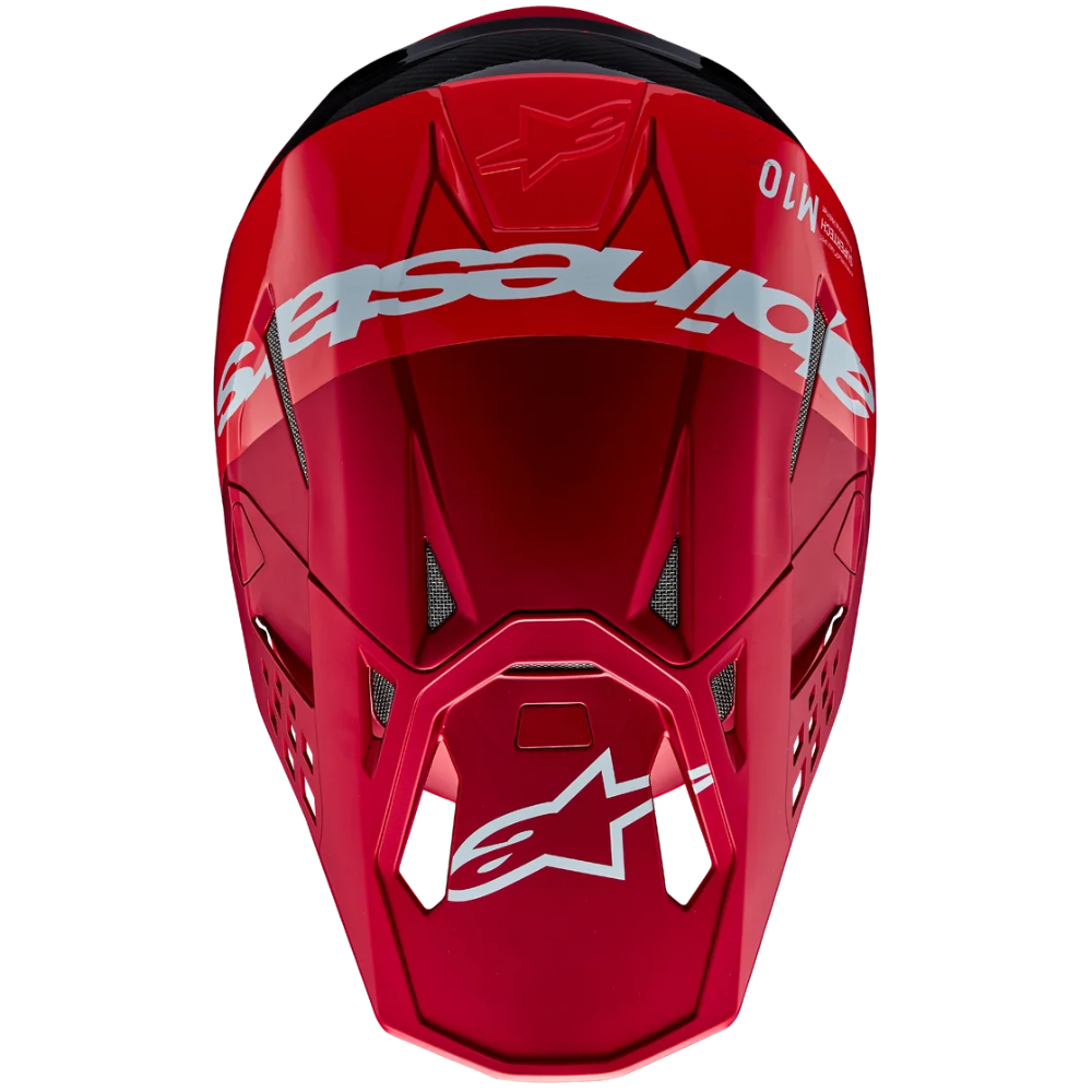 A red Alpinestars motocross helmet shown from a front-facing perspective on a solid white background.
