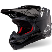 Black motocross helmet with red interior on a white background
