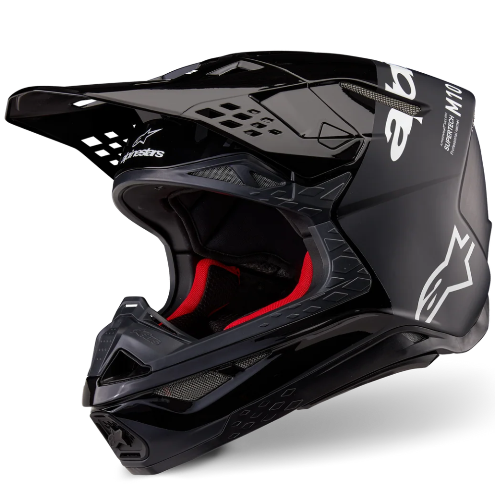 Black motocross helmet with red interior on a white background