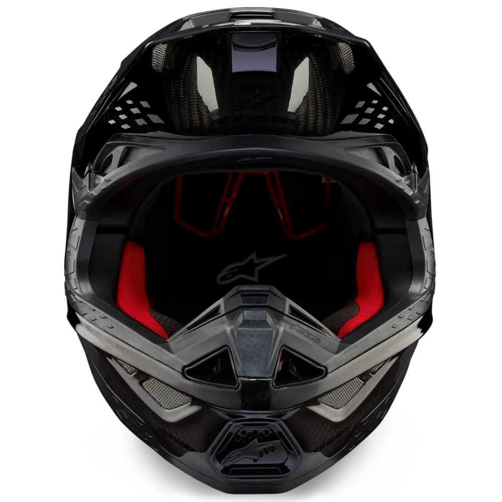 A black full-face motocross helmet with a clear visor and red interior lining, shown from a front-facing perspective on a solid white background.