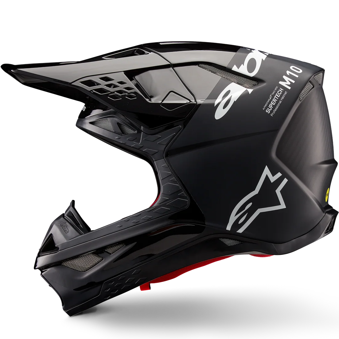 A black Alpinestars M10 full-face motocross helmet with white logo graphics and a small red accent near the chin, shown from a side profile on a white background.