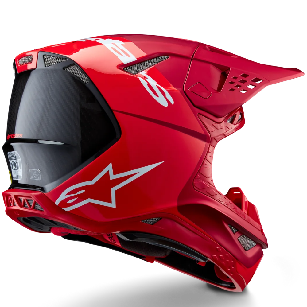 A red Alpinestars full-face motocross helmet with a dark visor, featuring the brand's white star logo on the side, shown against a solid white background with a soft shadow.