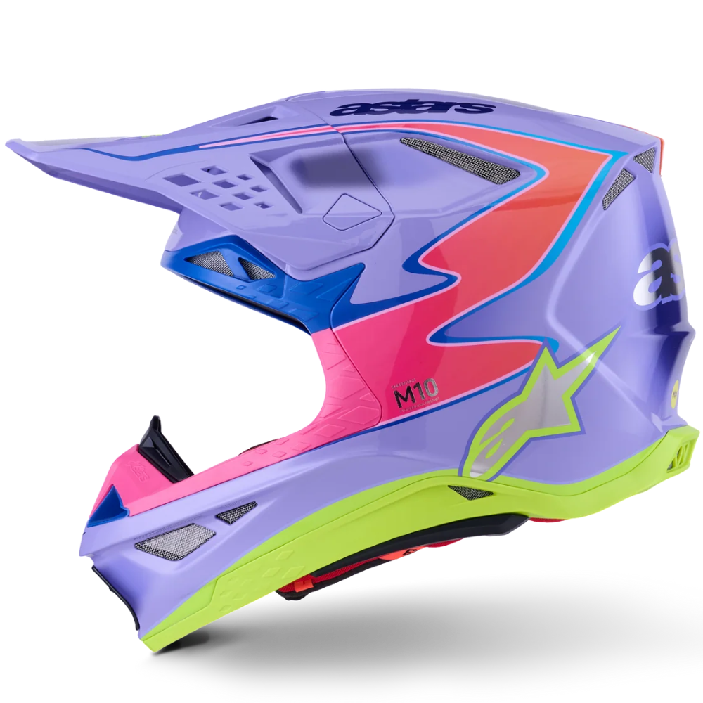 A motocross helmet in a vibrant multicolor design featuring a lavender-purple base with neon pink, blue, lime green, and coral-red graphic accents, shown from a side profile on a white background.