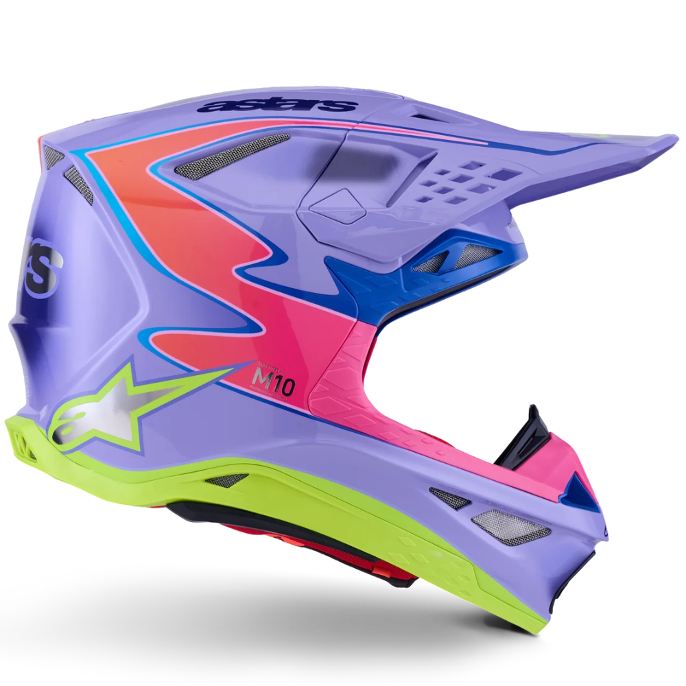 A motocross helmet in a vibrant purple, pink, and lime green colorway, featuring Alpinestars branding and a matching purple visor, shown against a plain white background.