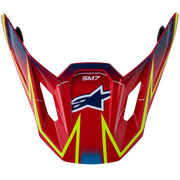Red Alpinestars SM7 motocross helmet visor with yellow and blue graphics, shown on a plain white background.