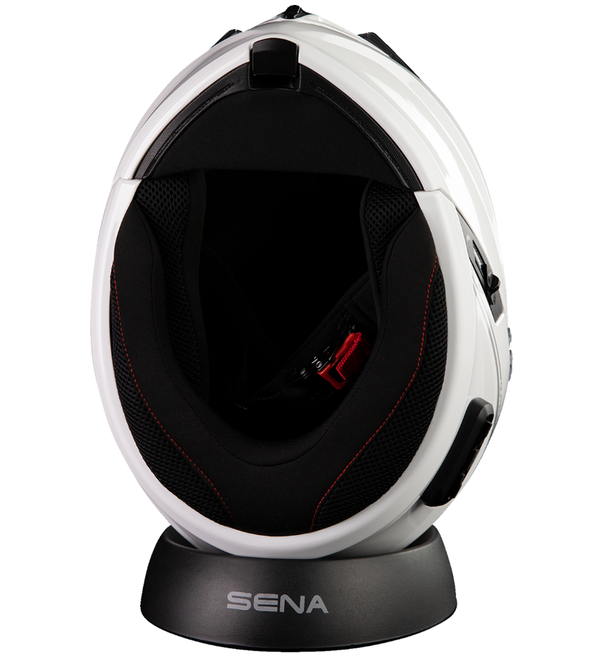 White and black helmet with 'Sena' branding on a stand