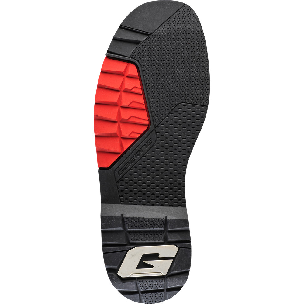 The outsole of a shoe shown in a top-down view, featuring a black textured rubber base with a bright red textured section on the forefoot and a silver and black 'G' logo at the heel.