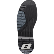 The outsole of a shoe, featuring a black and dark gray tread pattern with a silver and black 'G' logo at the heel, on a solid white background.