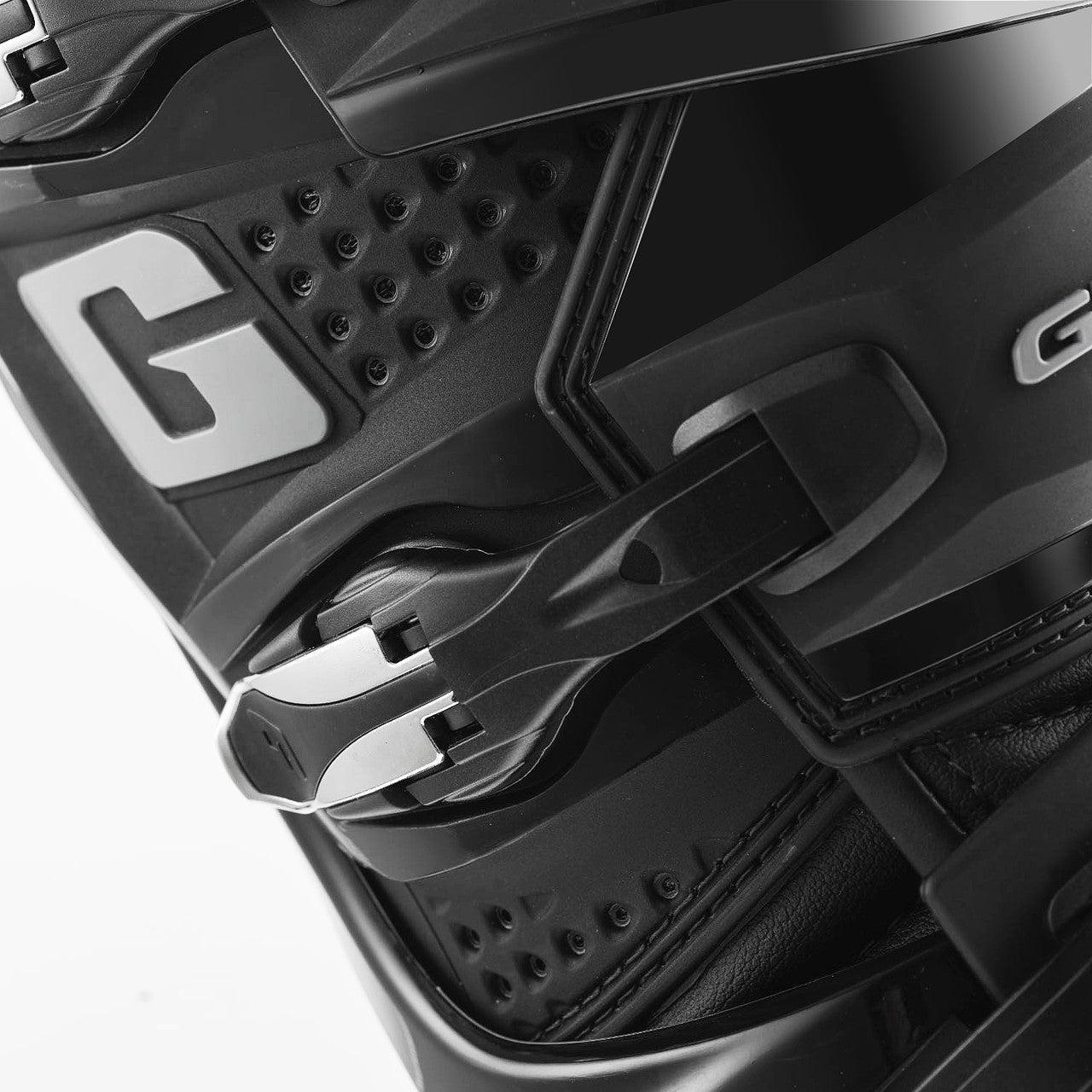 Close-up of a black helmet with a visible brand logo on a white background