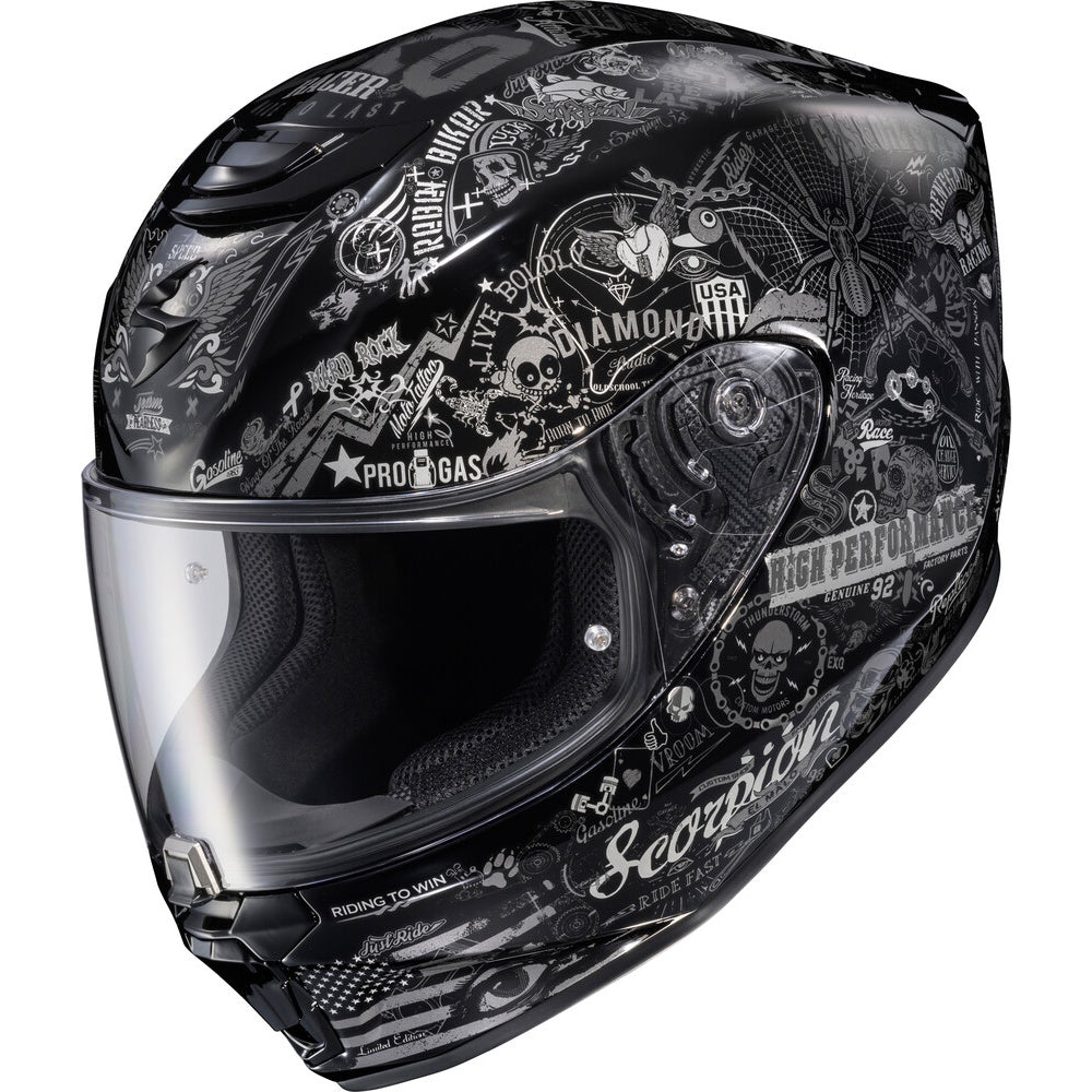 A black full-face motorcycle helmet with a glossy black and white graphic print featuring skulls, roses, and various biker-style text and logos, including 'Scorpion' and 'Kenda'.