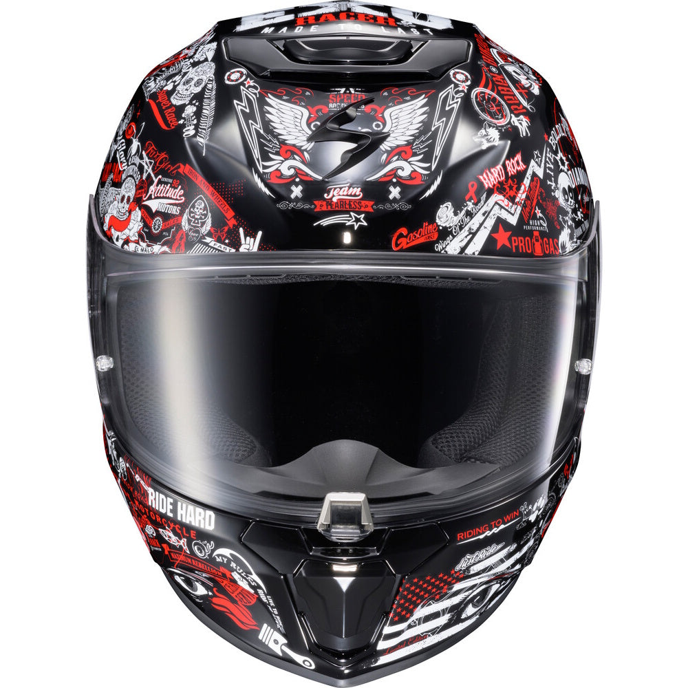 A full-face motorcycle helmet with a glossy black base and a detailed graphic print in red, white, and gray. The graphic features a large winged skull on the forehead, various street-style illustrations, and text including 'RIDE HARD' and 'PRO RIDER'.