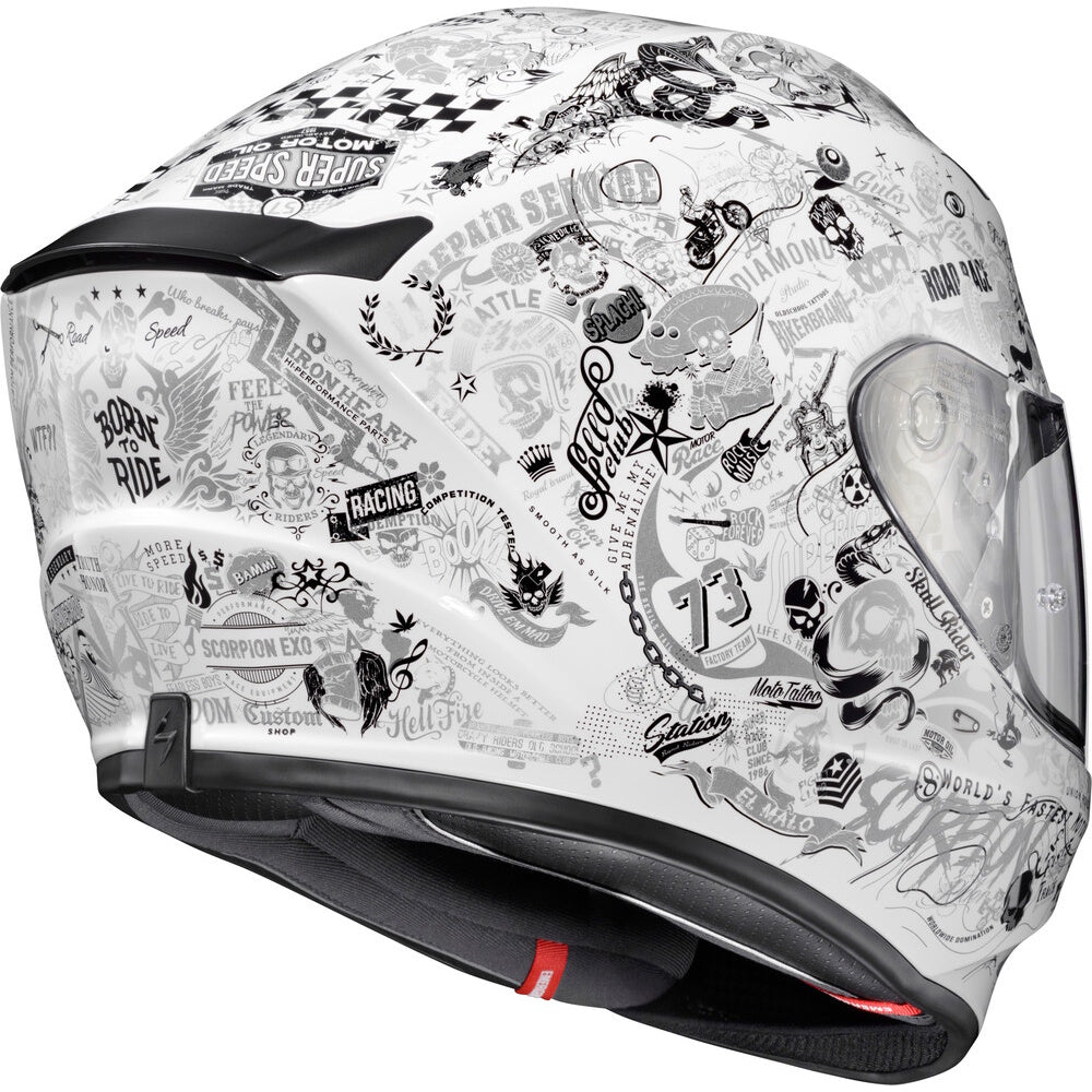 A white full-face motorcycle helmet decorated with a dense black and gray graphic collage featuring biker text, skulls, motorcycles, and racing motifs, shown against a plain white background.