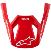 A red Alpinestars SM3 motocross helmet face guard with white branding and logo, shown against a plain white background.