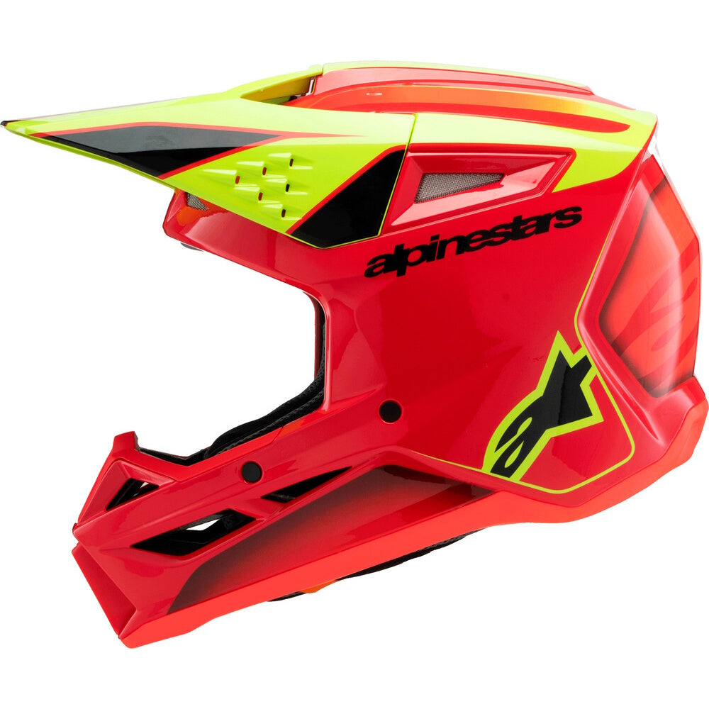 A red and neon yellow Alpinestars full-face motocross helmet with a black visor and interior padding, shown from a three-quarters angle on a white background.