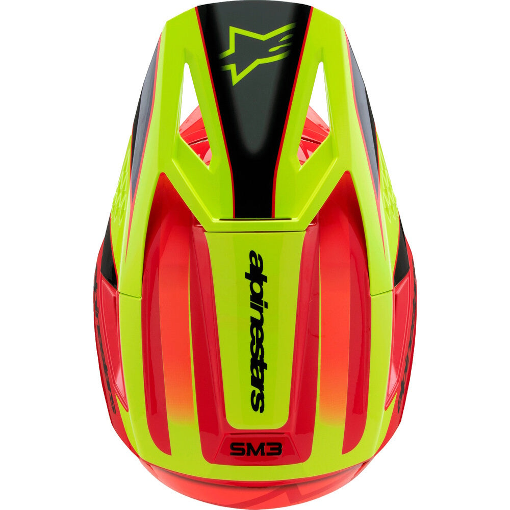 A red and neon yellow Alpinestars full-face motocross helmet with a black visor and interior padding, shown from a three-quarters angle on a white background.
