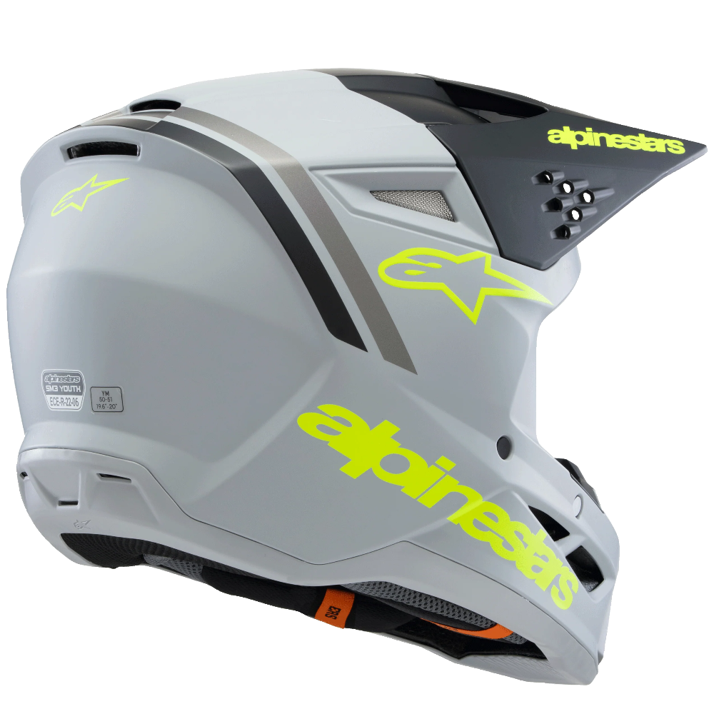 A full-face mountain bike helmet in white and black with bright neon yellow-green Alpinestars branding, shown from a side profile on a white background.