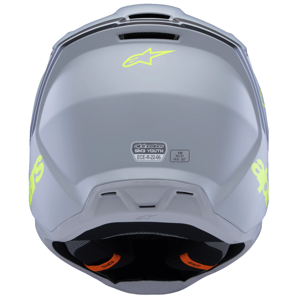 A rear view of a light gray Alpinestars motorcycle helmet with neon yellow-green logo accents and orange visor lining, shown on a solid white background.