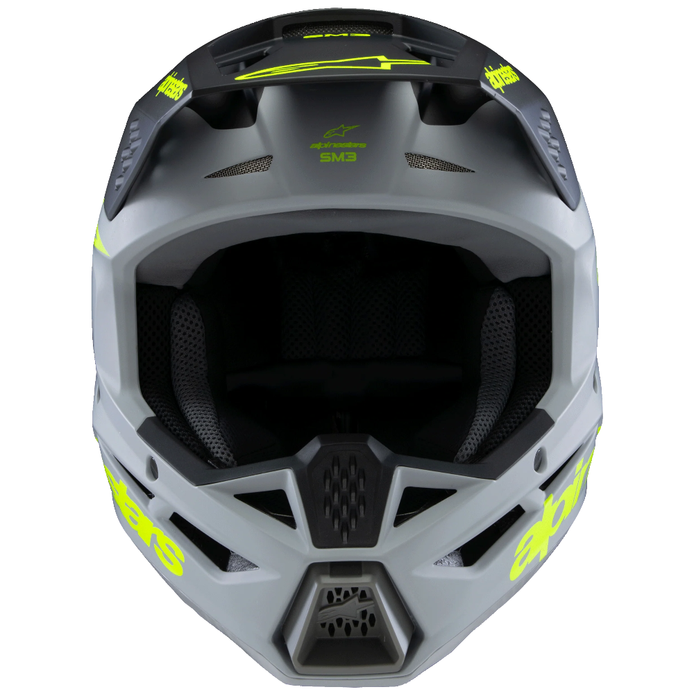 Gray motocross helmet with yellow accents on a white background