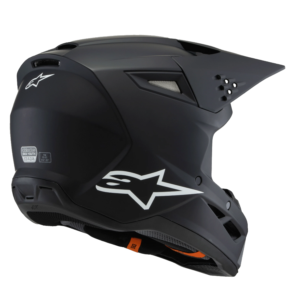 Matte black full-face motocross helmet with a white Alpinestars logo on the side, shown from a three-quarters angle against a white background.