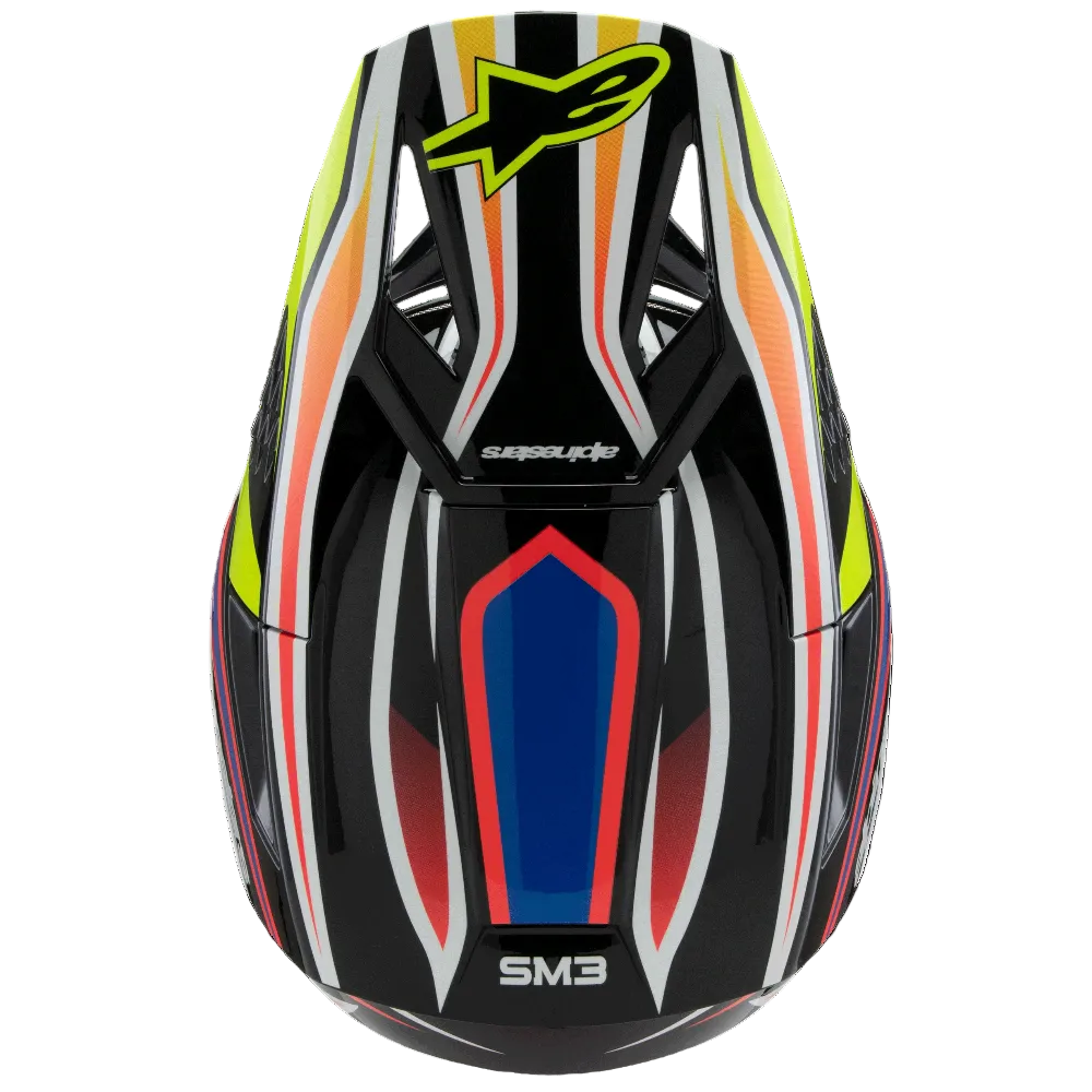 A close-up rear view of a motocross helmet with a black base and a vibrant graphic pattern of white, red, orange, and neon yellow stripes, featuring the Alpinestars logo on top.