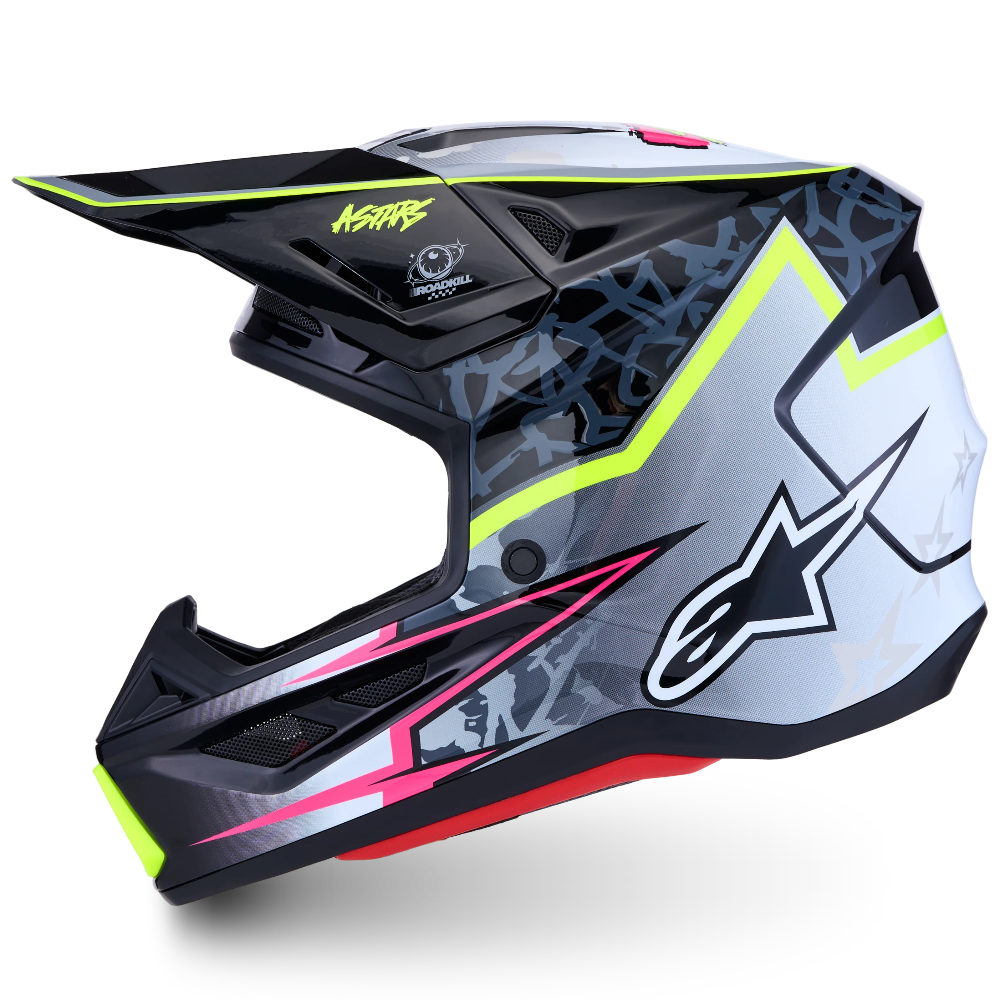A full-face motocross helmet by Alpinestars and K&N Brands, featuring a black, white, and gray graphic pattern with neon yellow, pink, and red accents, shown from a side profile on a white background.