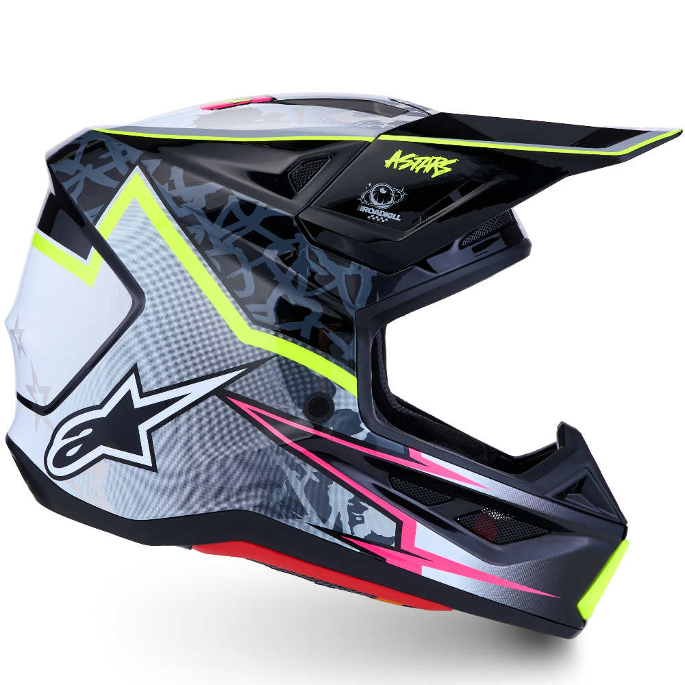 Alpinestars motocross helmet in black, white, and gray with neon yellow, pink, and red graphic accents, shown from a three-quarters angle on a white background.