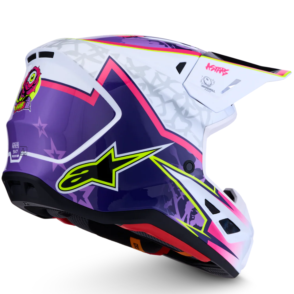 A motocross helmet by Alpinestars in a white, purple, and pink colorway with neon yellow-green accents, shown from a three-quarters angle on a white background.
