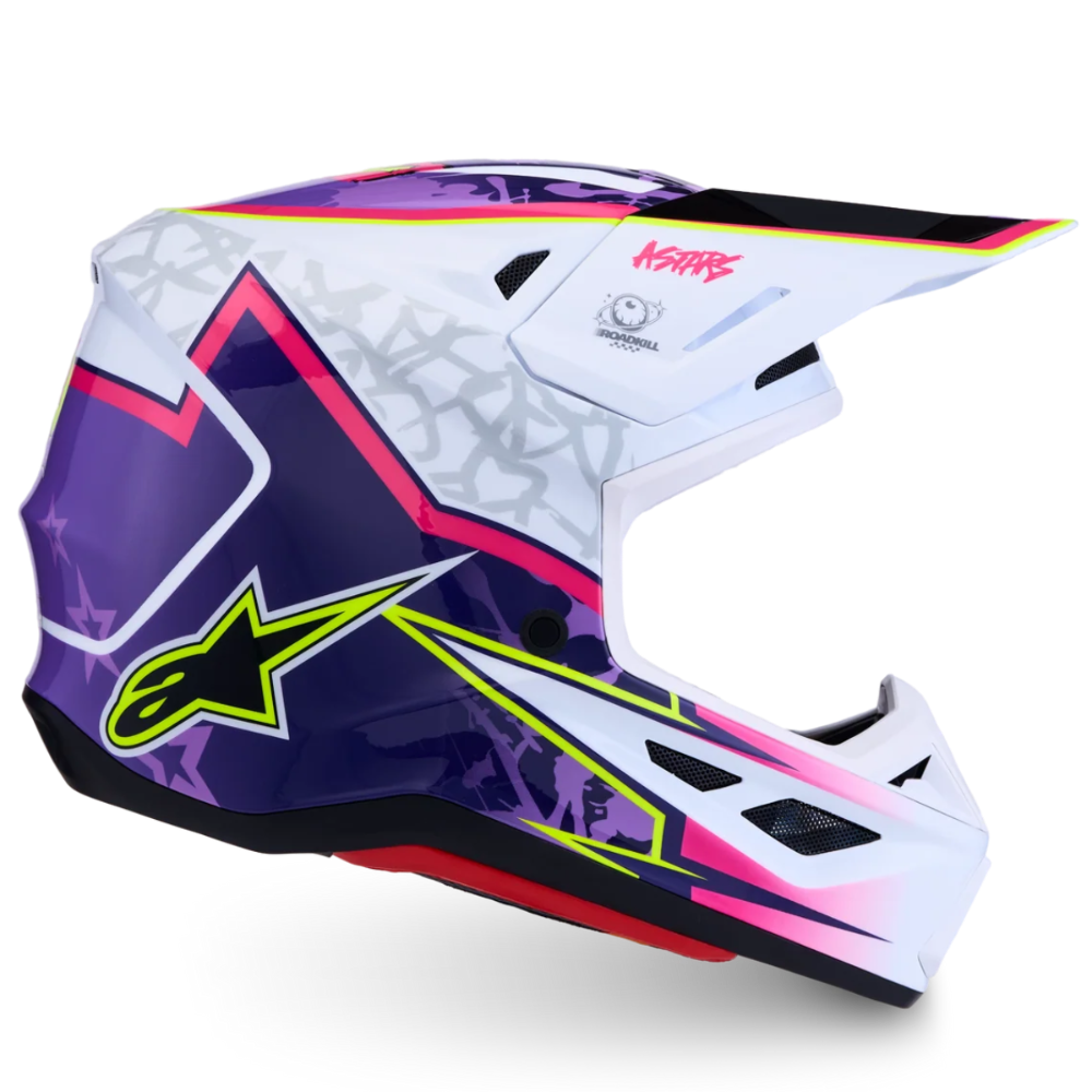 A full-face motocross helmet in white, purple, and black with vibrant pink and neon yellow graphic accents. The Alpinestars logo is visible on the side, and the K&N brand name is printed on the visor.