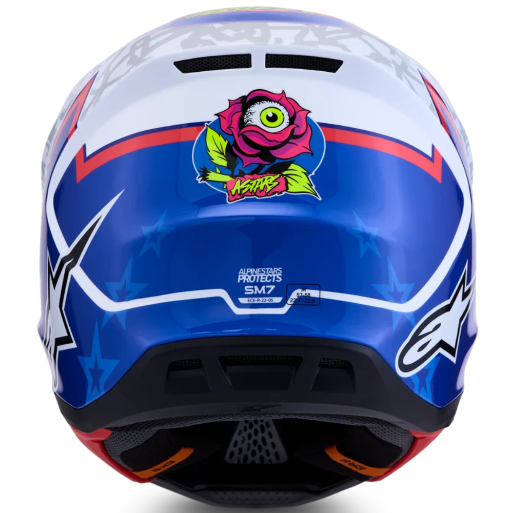 A rear view of an Alpinestars full-face motocross helmet in blue, white, and red, featuring a pink rose graphic with a green eye on the back.