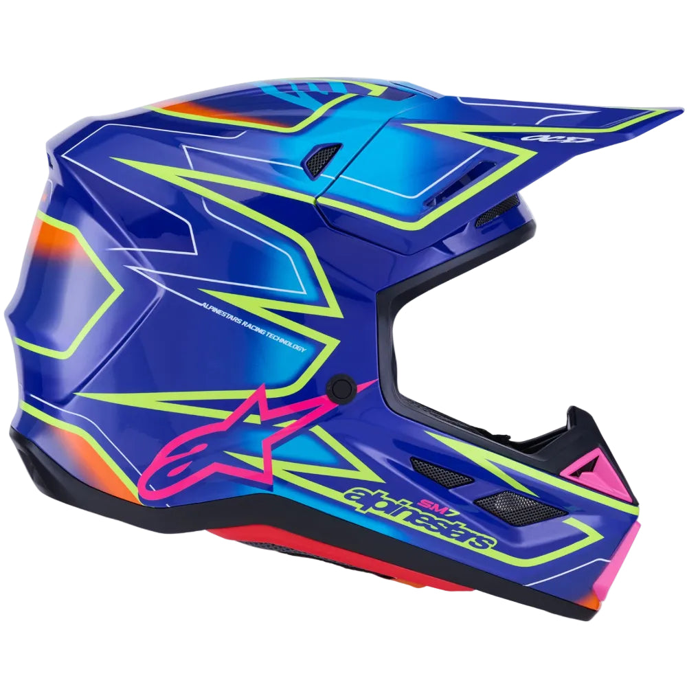 Alpinestars full-face motocross helmet in vibrant blue with neon yellow, pink, and orange graphic accents, shown from a side profile on a white background.