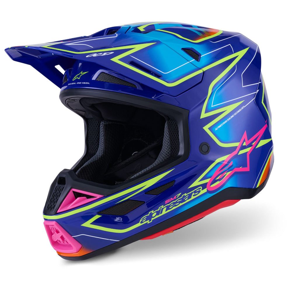 Alpinestars full-face motocross helmet in a vibrant blue colorway with neon lime green, hot pink, and orange graphic accents, shown from a three-quarters angle on a white background.
