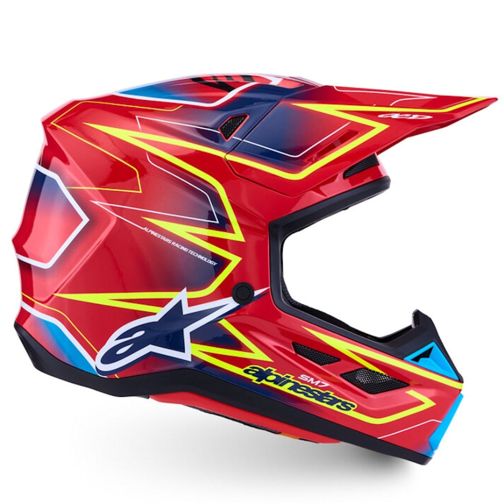 Red, blue, and yellow motocross helmet on a white background