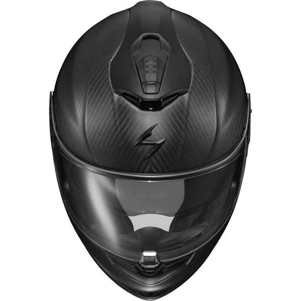 A black carbon fiber full-face motorcycle helmet with a clear visor, shown from a front-facing perspective on a solid white background.