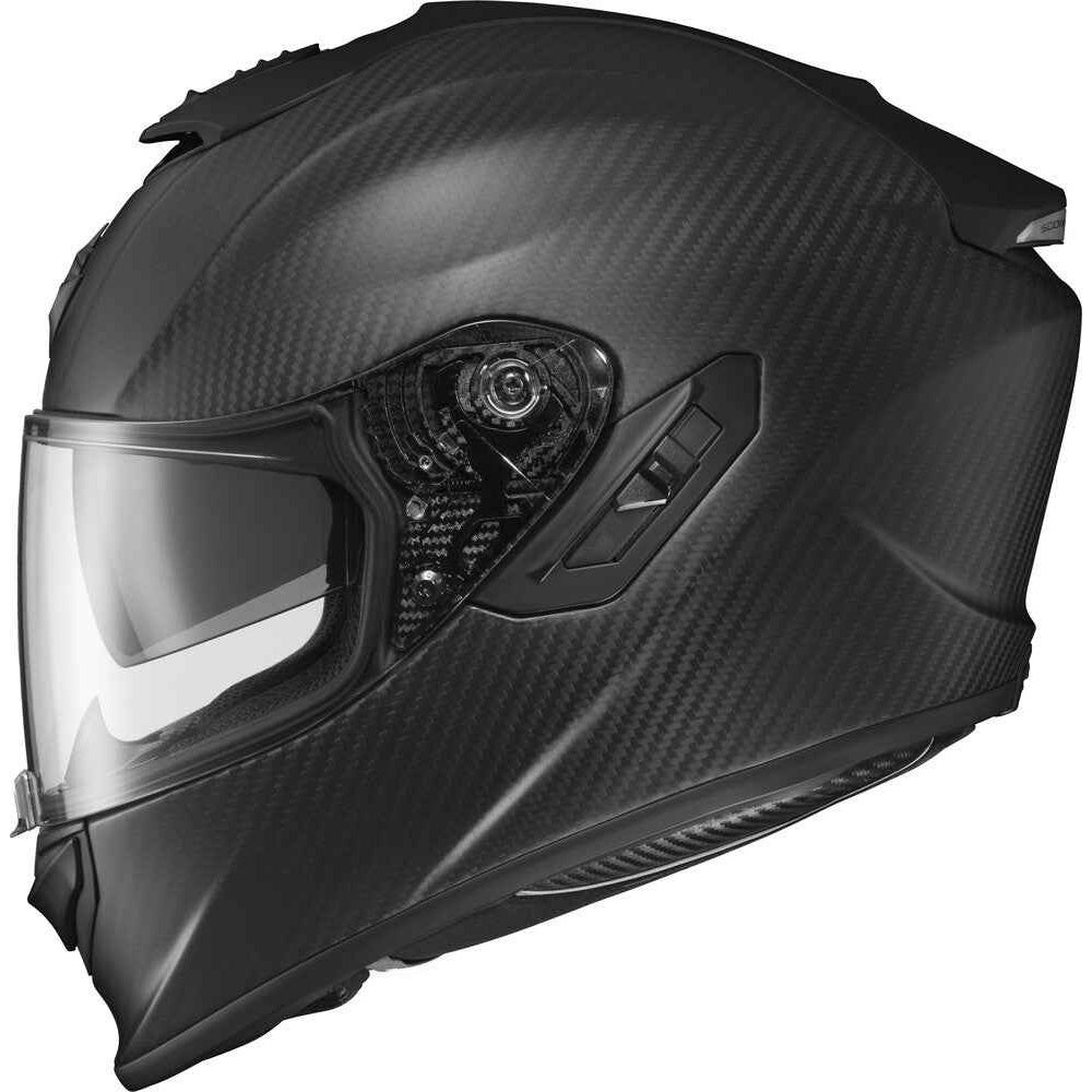A full-face motorcycle helmet with a matte black carbon fiber pattern, clear visor, and dark side vents, shown from a three-quarters angle on a white background.