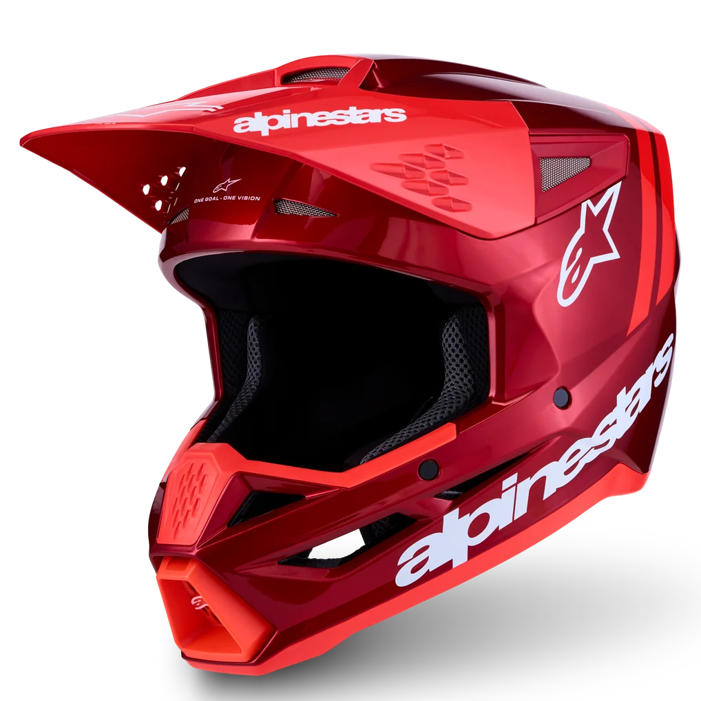 A red Alpinestars full-face motocross helmet with a glossy finish, white brand logos, and a black visor, shown on a clean white background with a soft shadow.