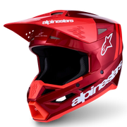 A red Alpinestars full-face motocross helmet with a glossy finish, white brand logos, and a black visor, shown on a clean white background with a soft shadow.