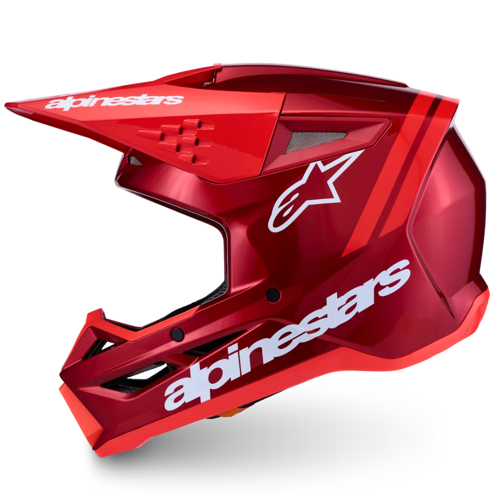 A red Alpinestars full-face mountain bike helmet with white branding, shown from a side profile against a clean white background.