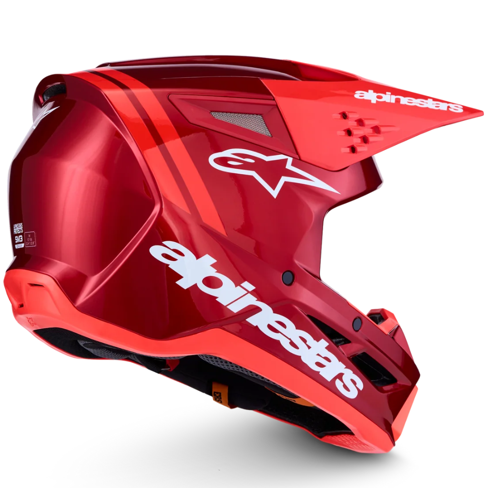 A glossy red Alpinestars full-face motocross helmet with white branding logos, shown from a three-quarters angle on a clean white background.