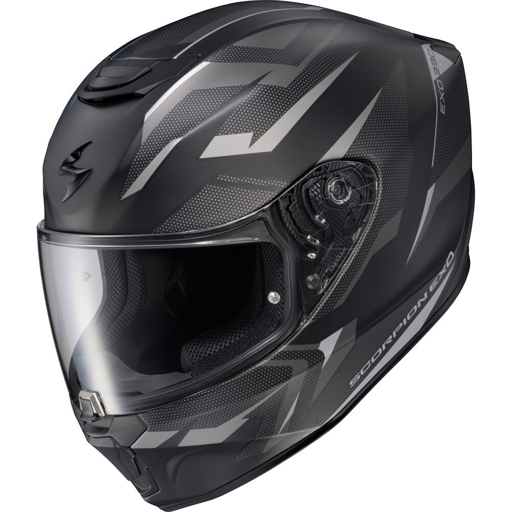 A black Scorpion EXR full-face motorcycle helmet with a clear visor, featuring a carbon-fiber textured pattern and silver-gray graphic accents.