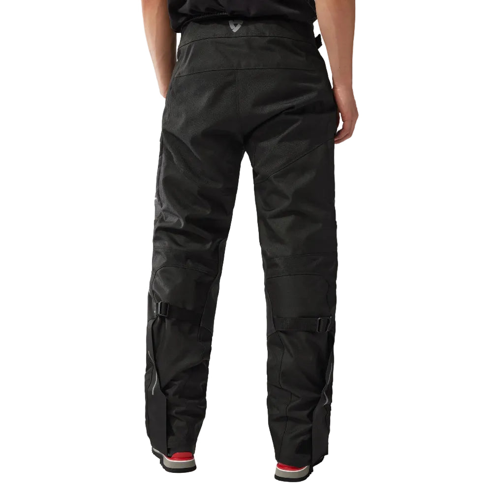 Person wearing black pants on a white background