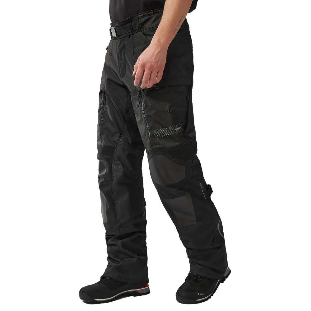 Person wearing black tactical pants on a white background