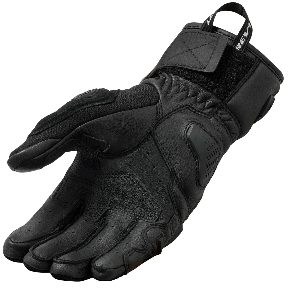 Black tactical glove on a light gray background