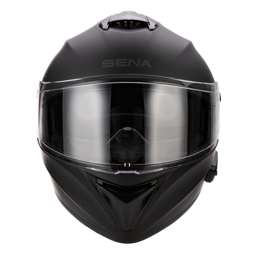 A matte black full-face motorcycle helmet with a clear visor, featuring the brand name 'SENA' printed in gray on the forehead, set against a plain white background.