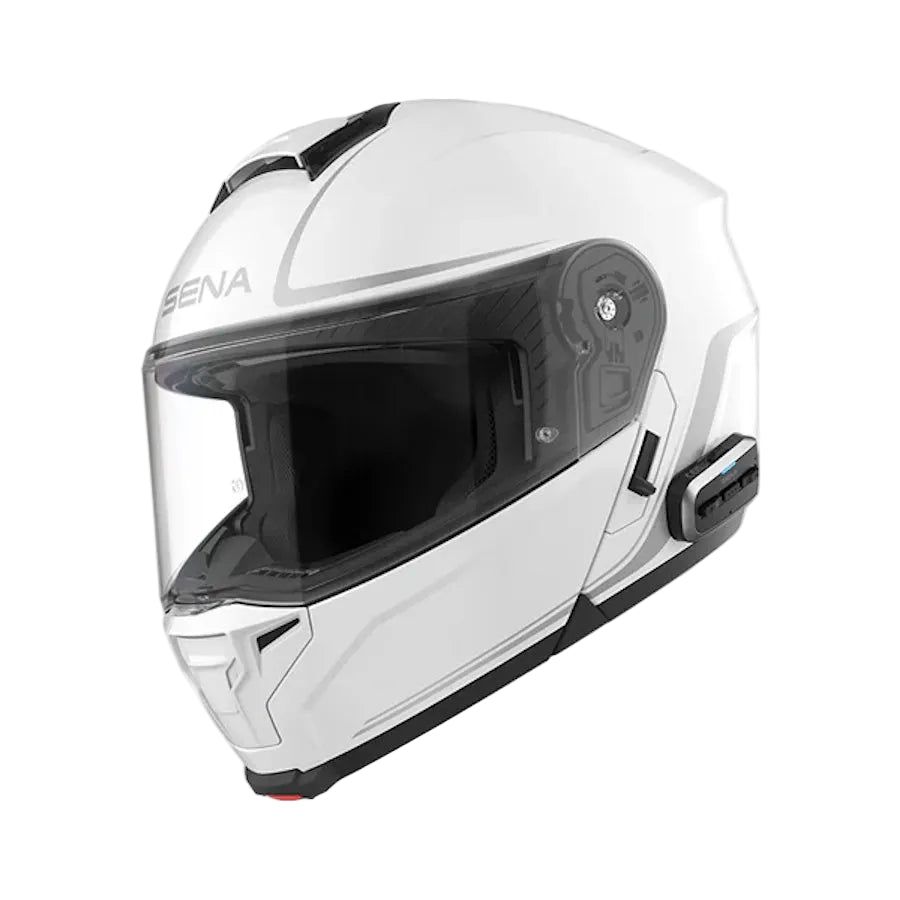 A white full-face motorcycle helmet with a clear visor and black trim, featuring the SENA brand name on the side, shown against a light gray background.