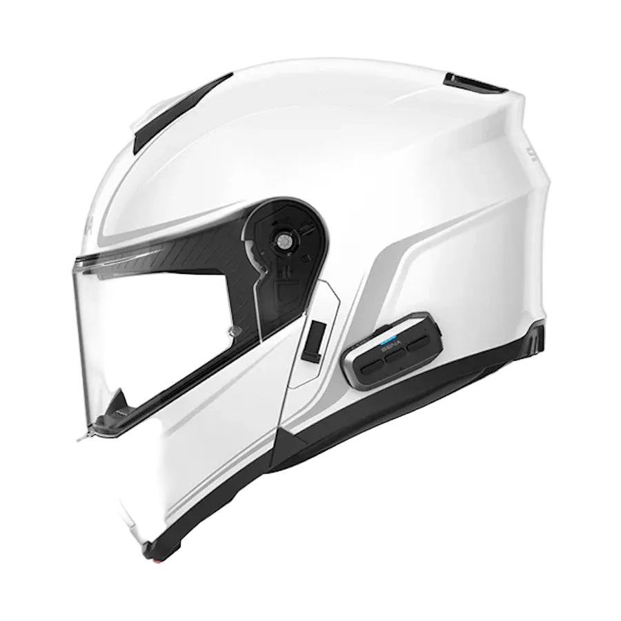 A white full-face motorcycle helmet with a clear visor and integrated black communication module, shown from a side profile on a light gray background.