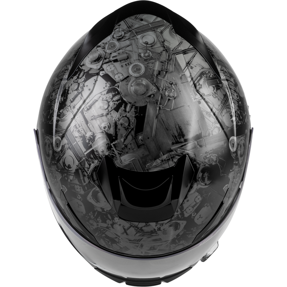 A full-face motorcycle helmet shown from the front, featuring a glossy black visor with a detailed grayscale industrial machinery graphic printed across the upper section.