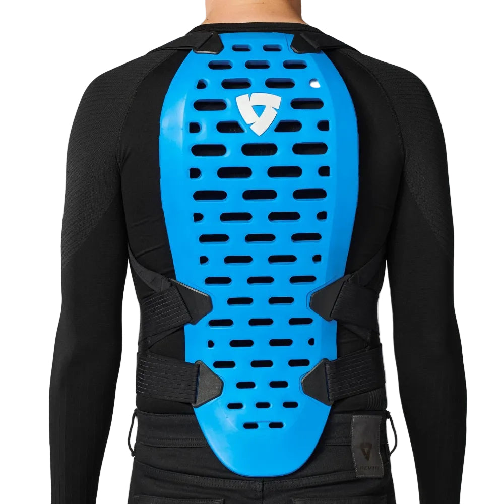 Person wearing a black long-sleeve shirt with a blue back protector on a white background