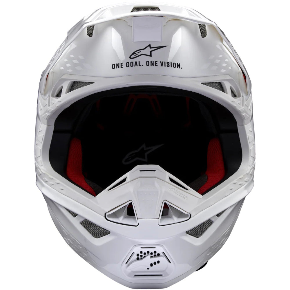 White motocross helmet with red interior on a white background