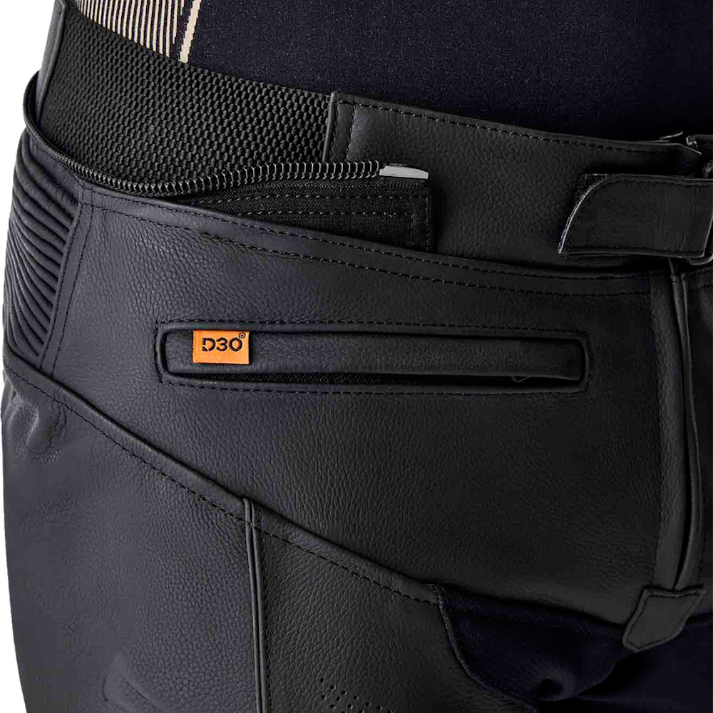 Close-up of a black leather waist belt with a zippered compartment and a small orange D3O logo patch, attached to dark pants.